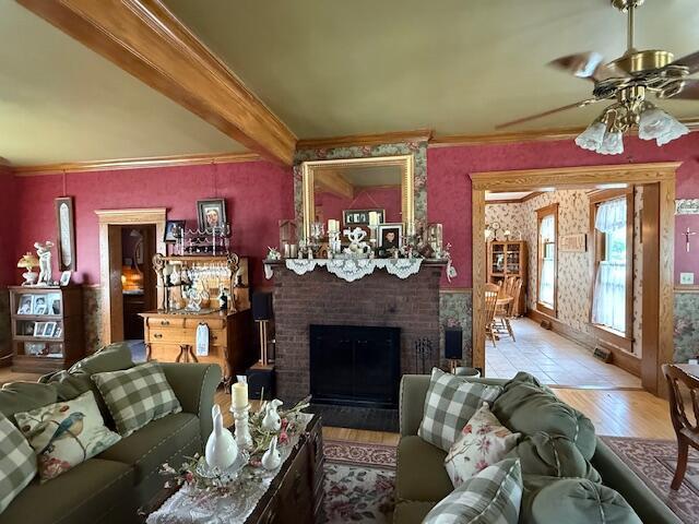 400 S Water St, Sparta, WI 54656 - living area with wood finished floors, a fireplace, ornamental molding, and ceiling fan