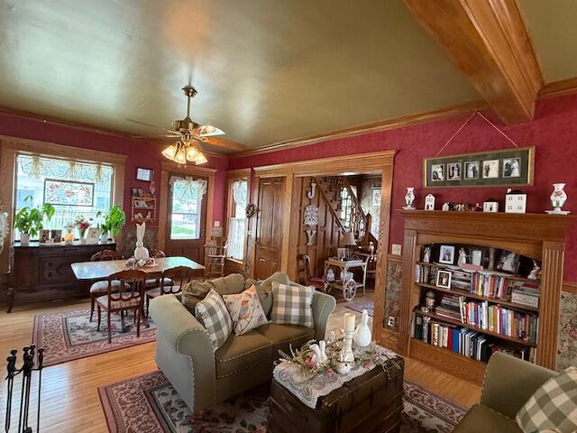 400 S Water St, Sparta, WI 54656 - living room featuring light wood finished floors, beamed ceiling, and ceiling fan