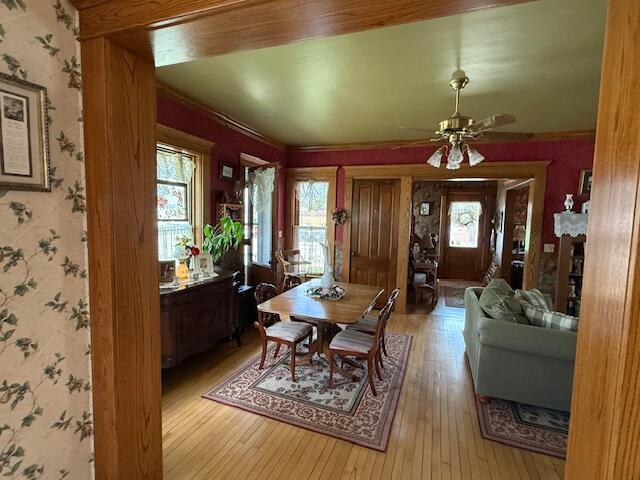 400 S Water St, Sparta, WI 54656 - dining space featuring hardwood / wood-style floors, wallpapered walls, and a ceiling fan
