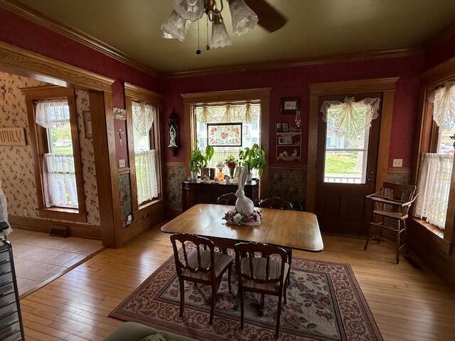400 S Water St, Sparta, WI 54656 - dining room with a ceiling fan, hardwood / wood-style flooring, wallpapered walls, and crown molding