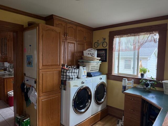 400 S Water St, Sparta, WI 54656 - laundry room with washer and clothes dryer and ornamental molding