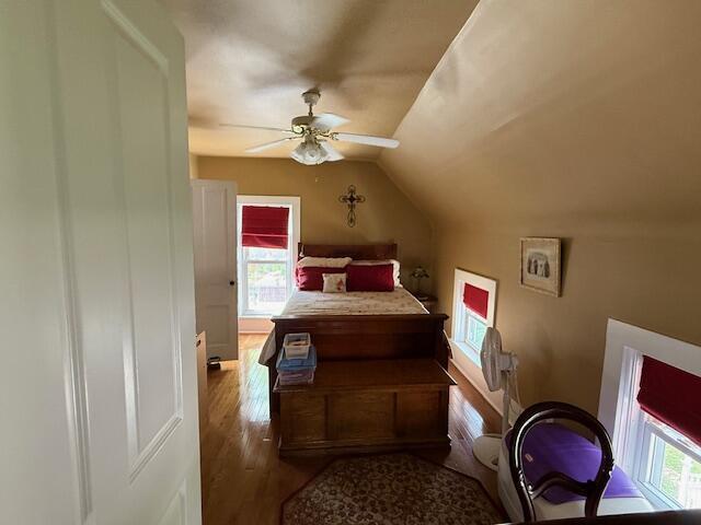 400 S Water St, Sparta, WI 54656 - bedroom with vaulted ceiling, wood finished floors, and ceiling fan