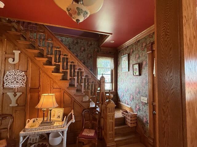 400 S Water St, Sparta, WI 54656 - stairway featuring crown molding and wallpapered walls