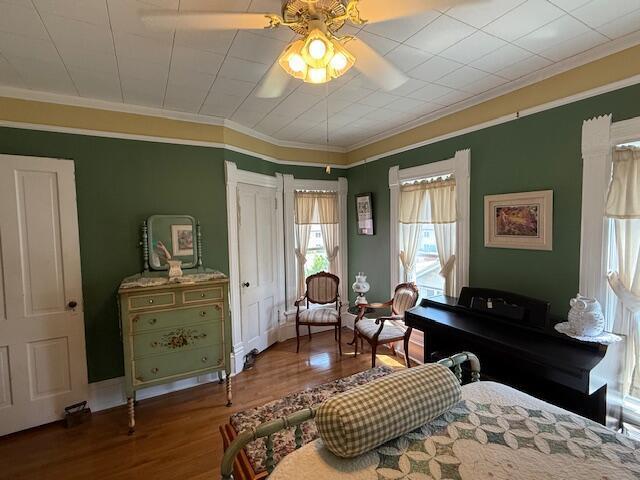 400 S Water St, Sparta, WI 54656 - bedroom with wood finished floors, crown molding, and ceiling fan