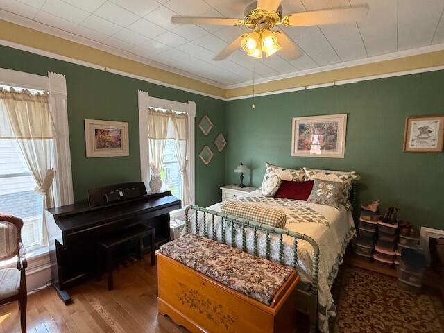 400 S Water St, Sparta, WI 54656 - bedroom featuring ornamental molding, wood finished floors, and ceiling fan