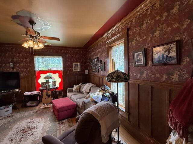 400 S Water St, Sparta, WI 54656 - living room with a wainscoted wall, a ceiling fan, and wallpapered walls