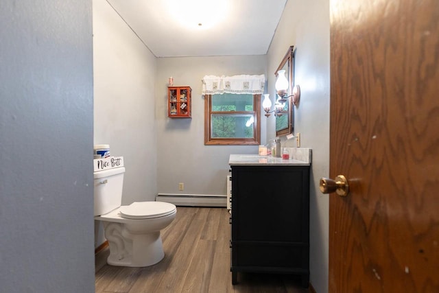 105 Glenview Dr, Tomah, WI 54660 - half bathroom with baseboard heating, wood finished floors, toilet, and vanity