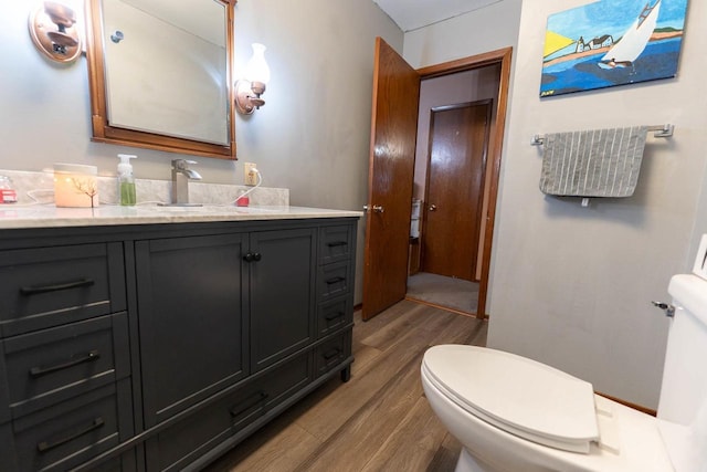 105 Glenview Dr, Tomah, WI 54660 - bathroom with wood finished floors, toilet, and vanity
