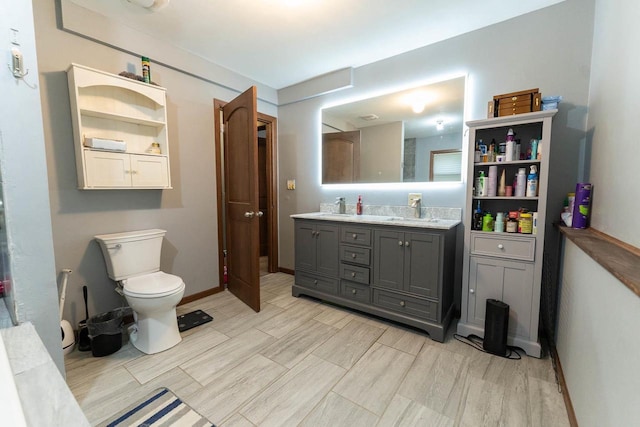 105 Glenview Dr, Tomah, WI 54660 - full bathroom with toilet, double vanity, and baseboards
