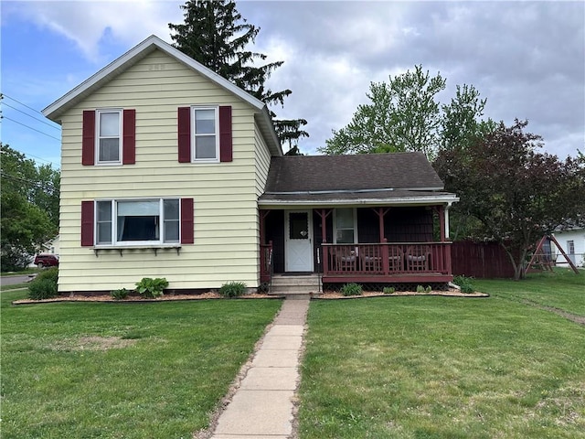403 Dwight St, Chippewa Falls, WI 54729 - traditional-style house featuring a porch, a front lawn, and a shingled roof