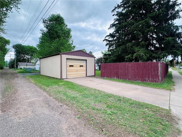 403 Dwight St, Chippewa Falls, WI 54729 - detached garage featuring fence and driveway