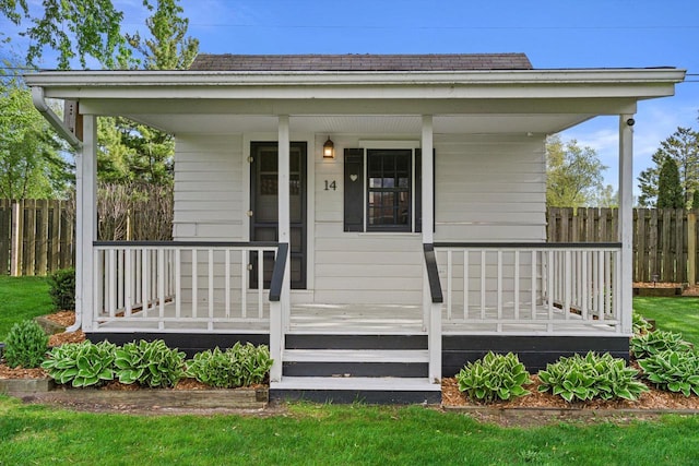 4531 Tabor Rd, Racine, WI 53402 - view of exterior entry with covered porch, fence, and roof with shingles