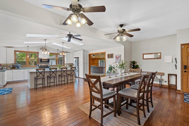 4531 Tabor Rd, Racine, WI 53402 - dining area featuring wood-type flooring, a ceiling fan, lofted ceiling, and a skylight