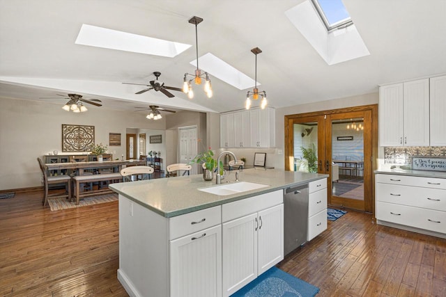 4531 Tabor Rd, Racine, WI 53402 - kitchen with a skylight, a sink, dishwasher, vaulted ceiling, and dark wood finished floors