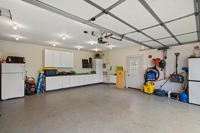 4531 Tabor Rd, Racine, WI 53402 - garage featuring freestanding refrigerator and a garage door opener