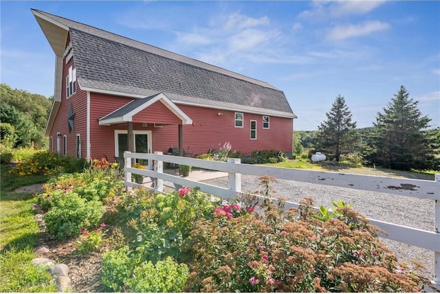 2929 170th St, Frederic, WI 54837 - view of side of home featuring a shingled roof and fence