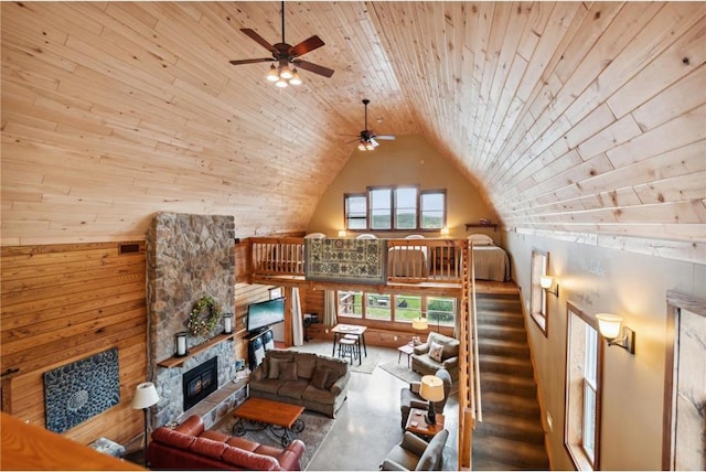 2929 170th St, Frederic, WI 54837 - living room with ceiling fan, wood ceiling, a fireplace, high vaulted ceiling, and wooden walls