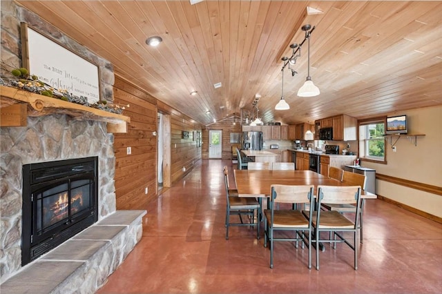 2929 170th St, Frederic, WI 54837 - dining room featuring wooden ceiling, healthy amount of natural light, vaulted ceiling, finished concrete floors, and wooden walls