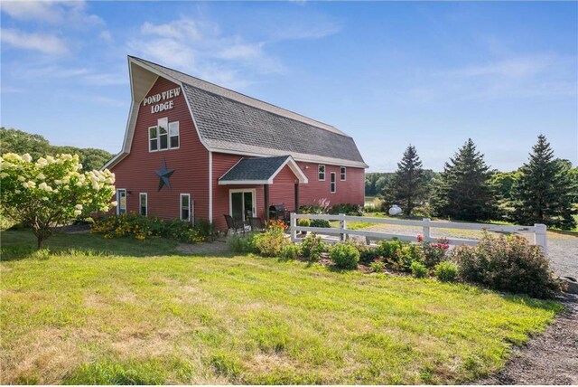 2929 170th St, Frederic, WI 54837 - back of house with a lawn, a shingled roof, and a gambrel roof