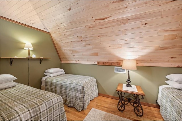 2929 170th St, Frederic, WI 54837 - bedroom featuring wood finished floors, vaulted ceiling, wooden ceiling, and baseboards