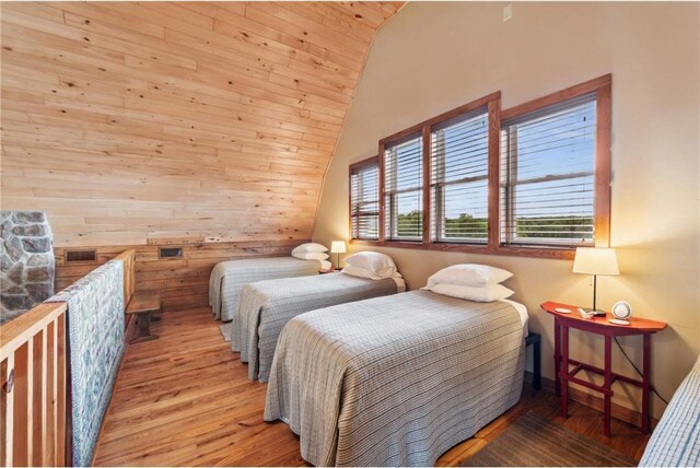 2929 170th St, Frederic, WI 54837 - bedroom featuring wood finished floors, vaulted ceiling, wooden ceiling, and wooden walls
