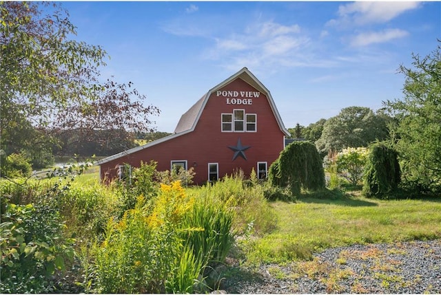 2929 170th St, Frederic, WI 54837 - view of side of home featuring a barn, a gambrel roof, and an outdoor structure