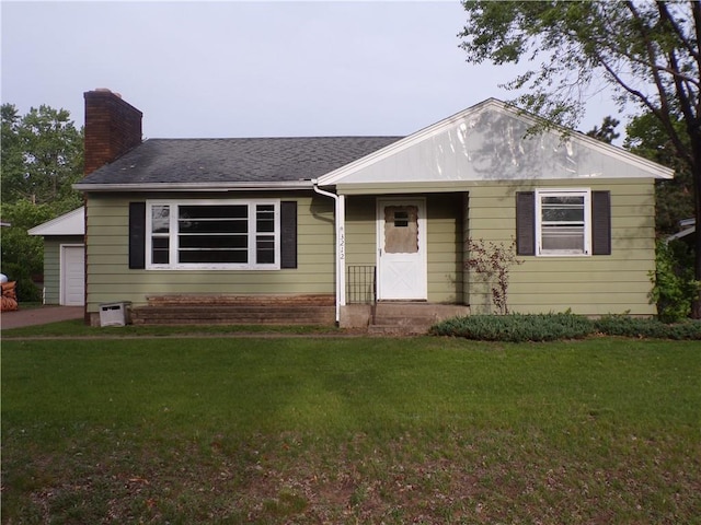 3212 Venus Ave, Eau Claire, WI 54703 - view of front of house featuring a chimney, a front yard, and a garage