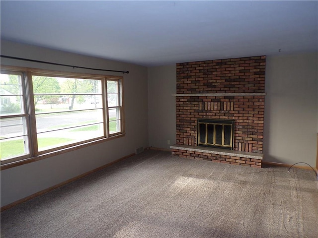 3212 Venus Ave, Eau Claire, WI 54703 - unfurnished living room with carpet flooring, baseboards, and a brick fireplace