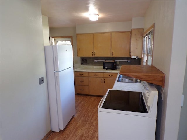 3212 Venus Ave, Eau Claire, WI 54703 - kitchen featuring freestanding refrigerator, electric range oven, light wood-style floors, black microwave, and light countertops