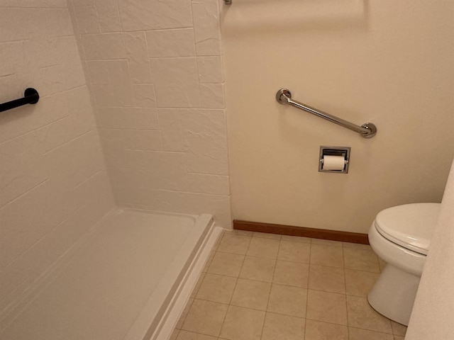301 Harbour Town Dr Unit 227, Madison, WI 53717 - bathroom with toilet, a shower, tile patterned flooring, and baseboards