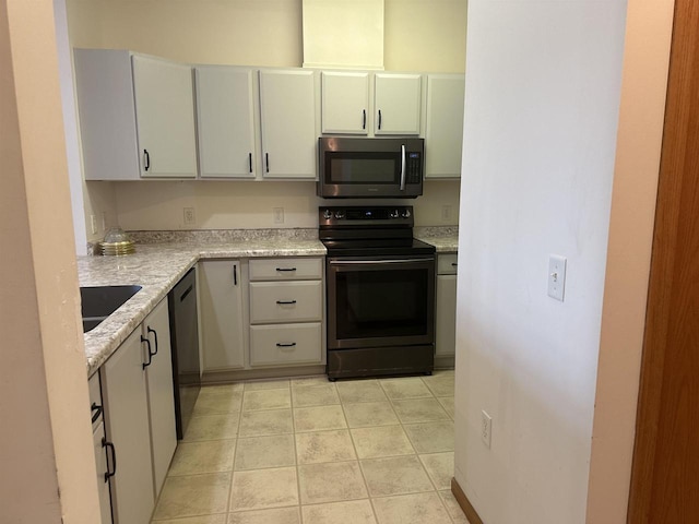301 Harbour Town Dr Unit 227, Madison, WI 53717 - kitchen featuring range with electric cooktop, stainless steel microwave, dishwashing machine, and light tile patterned flooring