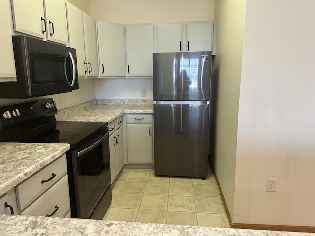 301 Harbour Town Dr Unit 227, Madison, WI 53717 - kitchen featuring freestanding refrigerator, black electric range, light countertops, and baseboards