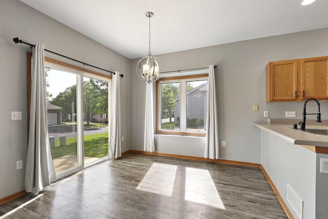 4669 S Forest Point Blvd, New Berlin, WI 53151 - unfurnished dining area with a sink, plenty of natural light, a chandelier, and wood finished floors