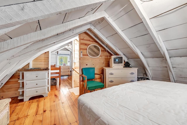 W6769 S Silver Lake Rd, Wautoma, WI 54982 - bedroom with wooden walls, light wood-style flooring, and vaulted ceiling