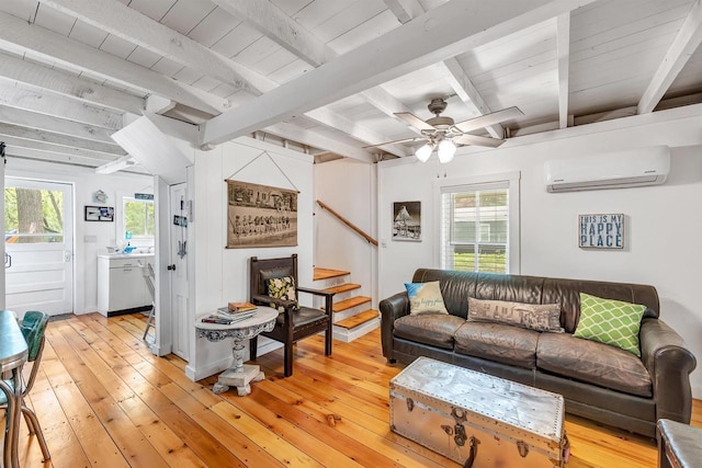 W6769 S Silver Lake Rd, Wautoma, WI 54982 - living area with a wall mounted AC, light wood-style floors, plenty of natural light, beam ceiling, and stairs