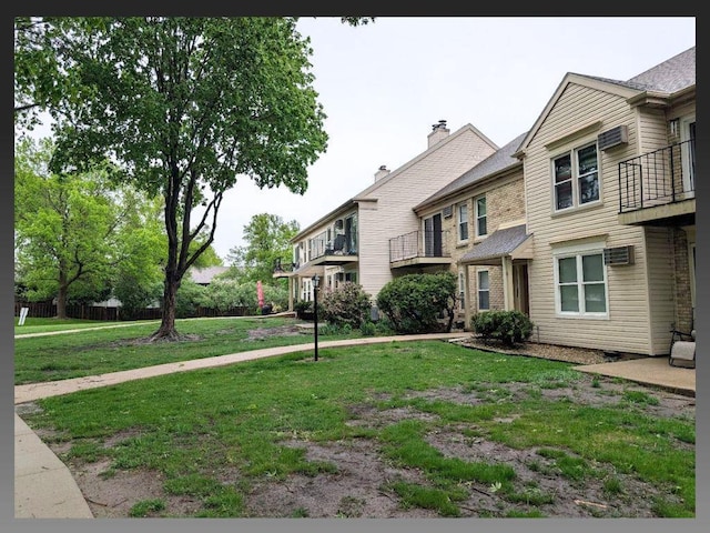6710 Park Ridge Dr Unit B, Madison, WI 53719 - view of front of property featuring a front yard, a balcony, and an AC wall unit