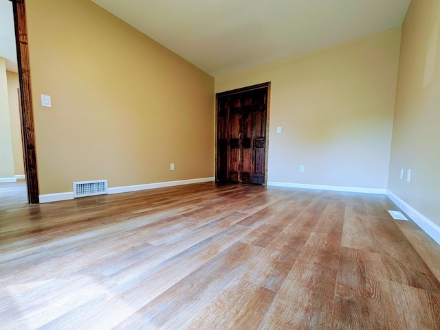 73 Church St, Montello, WI 53949 - spare room featuring light wood-style floors, baseboards, and vaulted ceiling