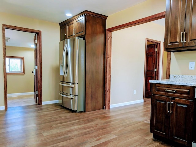 73 Church St, Montello, WI 53949 - kitchen featuring stainless steel fridge, light wood-type flooring, dark brown cabinetry, baseboards, and recessed lighting