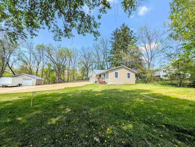 73 Church St, Montello, WI 53949 - view of green lawn featuring a detached garage