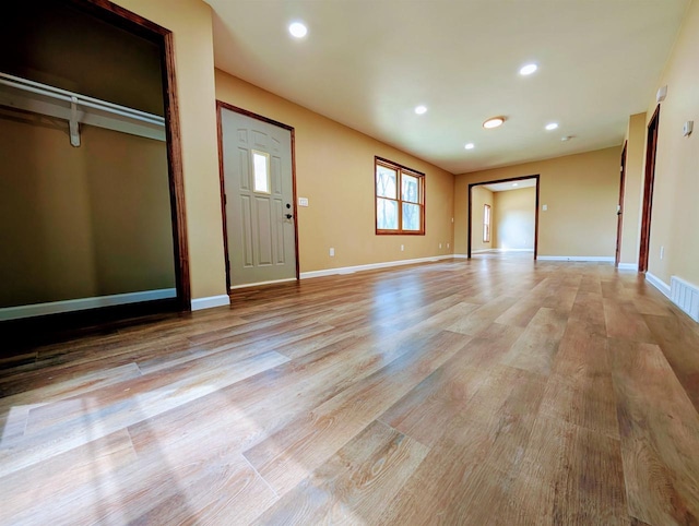 73 Church St, Montello, WI 53949 - unfurnished living room with light wood-type flooring, recessed lighting, and baseboards
