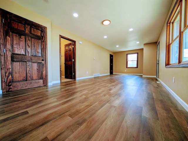 73 Church St, Montello, WI 53949 - unfurnished living room with wood finished floors, baseboards, and recessed lighting