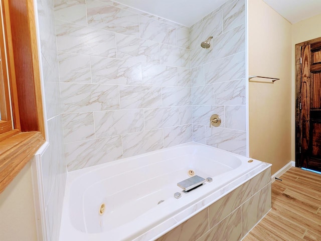 73 Church St, Montello, WI 53949 - full bath with a combined bath / shower with jetted tub, wood finished floors, and baseboards