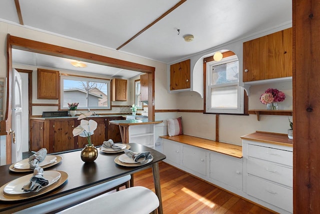 131 S Sidney St, Kimberly, WI 54136 - kitchen with brown cabinets, light wood finished floors, and plenty of natural light