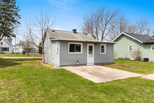 131 S Sidney St, Kimberly, WI 54136 - rear view of property featuring a patio, a yard, a chimney, and a shingled roof