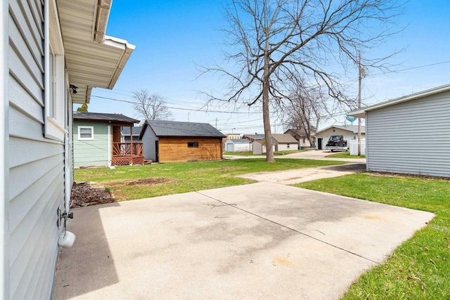 131 S Sidney St, Kimberly, WI 54136 - view of grassy yard featuring a patio area, an outbuilding, a residential view, and a wooden deck