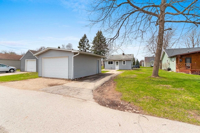 131 S Sidney St, Kimberly, WI 54136 - view of front of property with a garage, an outdoor structure, and a front lawn