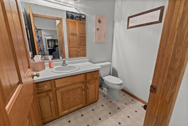 1500 Wolf Dr, West Bend, WI 53090 - ensuite bathroom featuring tile patterned floors, toilet, and vanity