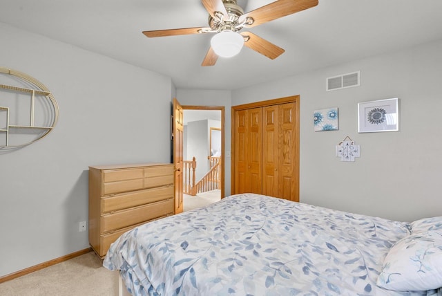 1500 Wolf Dr, West Bend, WI 53090 - bedroom with light colored carpet, a closet, baseboards, and a ceiling fan