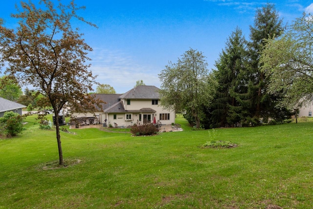 1500 Wolf Dr, West Bend, WI 53090 - view of grassy yard featuring a patio