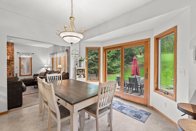 1500 Wolf Dr, West Bend, WI 53090 - dining room with plenty of natural light, baseboards, and light tile patterned flooring